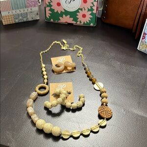 Wicker and other wooden accents and gold bead necklace and two earrings. Plunder